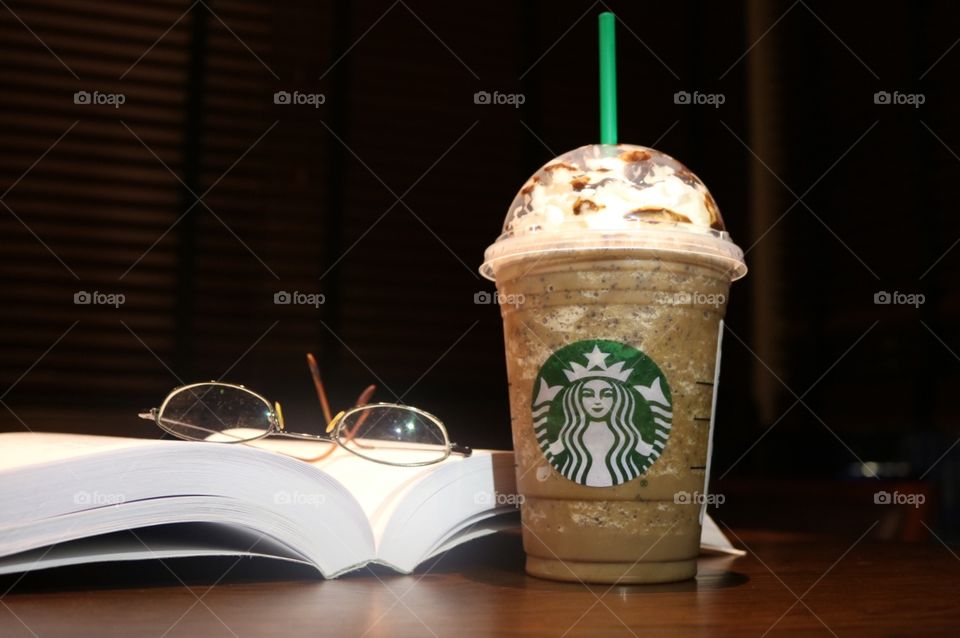 Starbucks Java Chip Frappuccino next to my book and pair of eye glasses