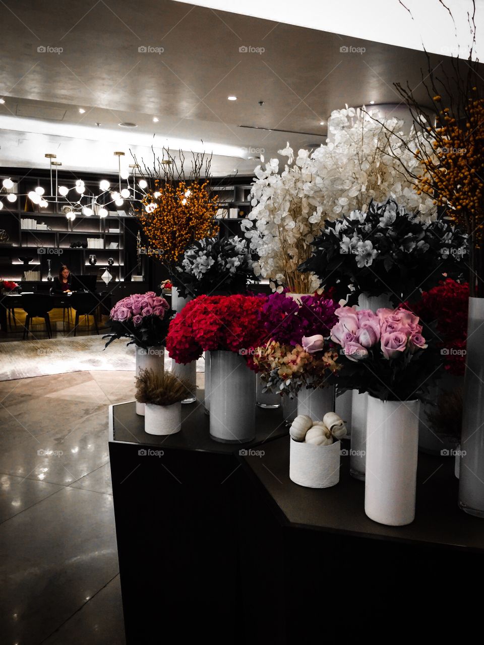 Gorgeous flower display in a hotel lobby with accented orange colour