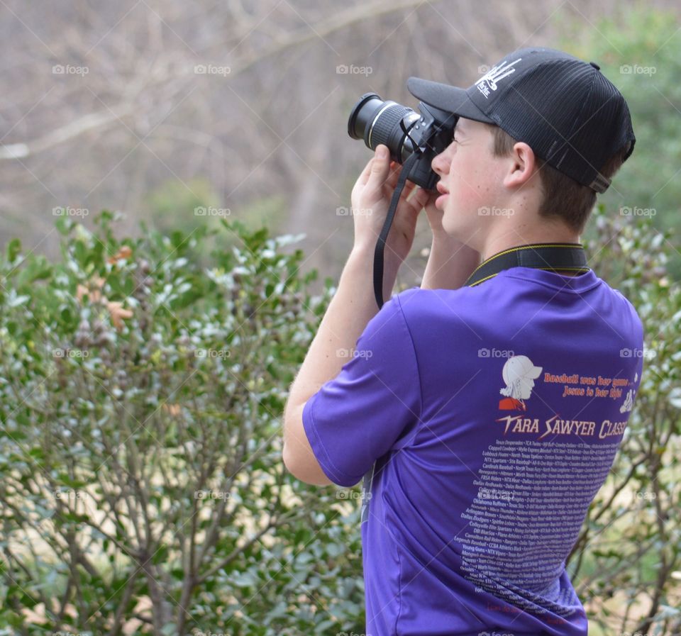 Side view of photographer capturing photo