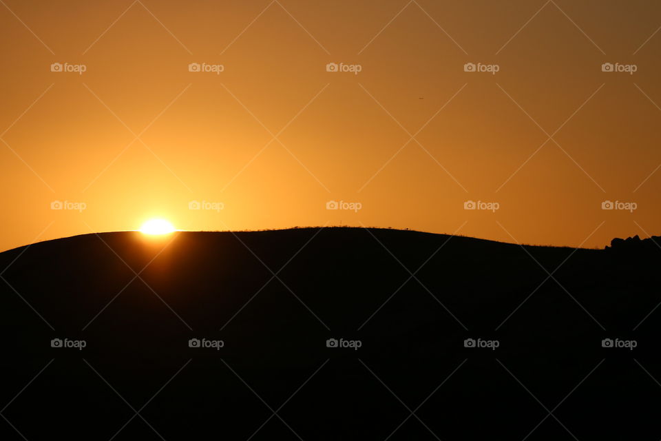 Sunset over hill