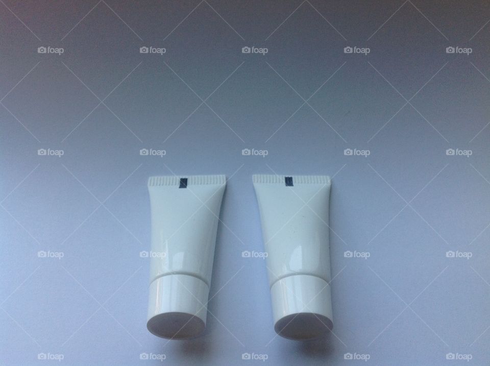 Copy space and white plastic tubes on white background.