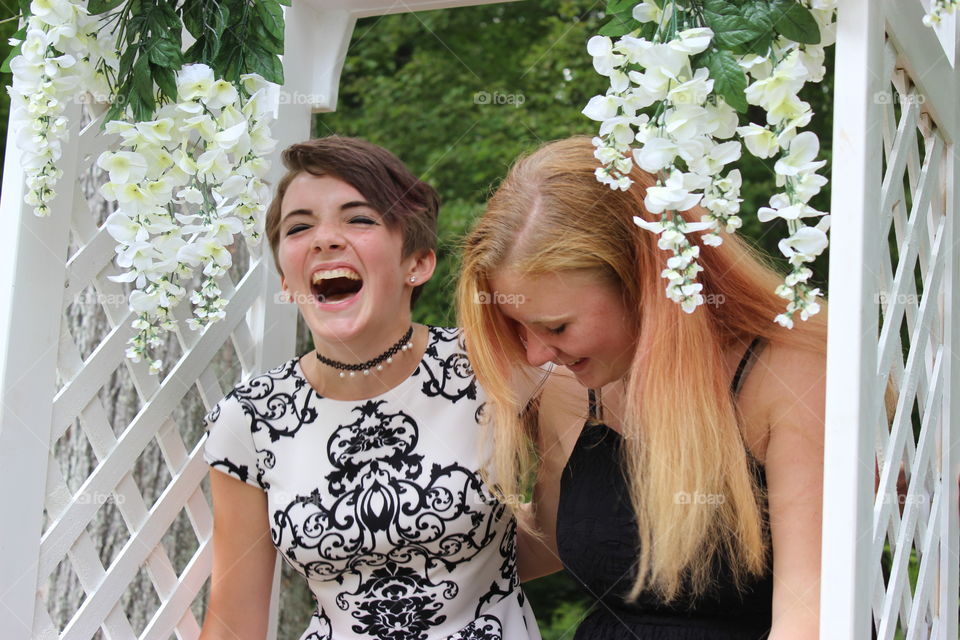Two girls laughing in an archway