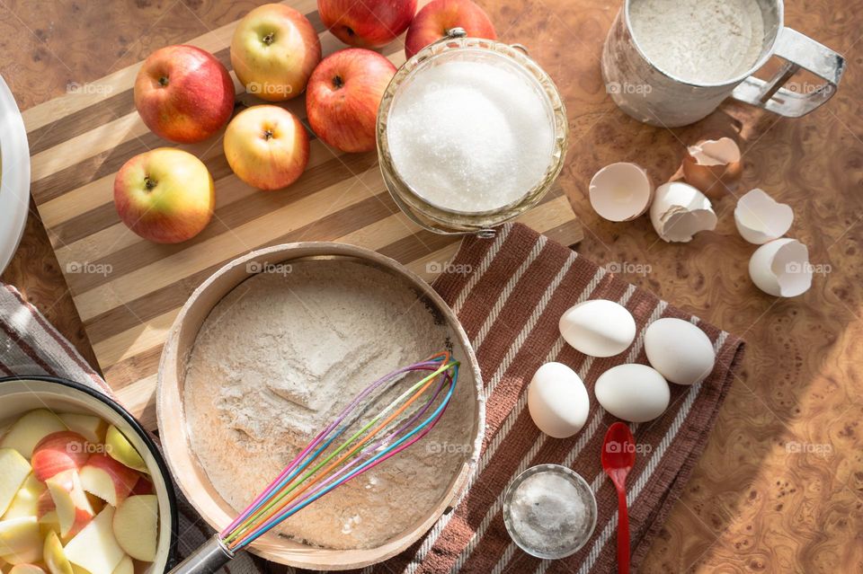 Making homemade puffed apple pie with eggs, sugar and flour.