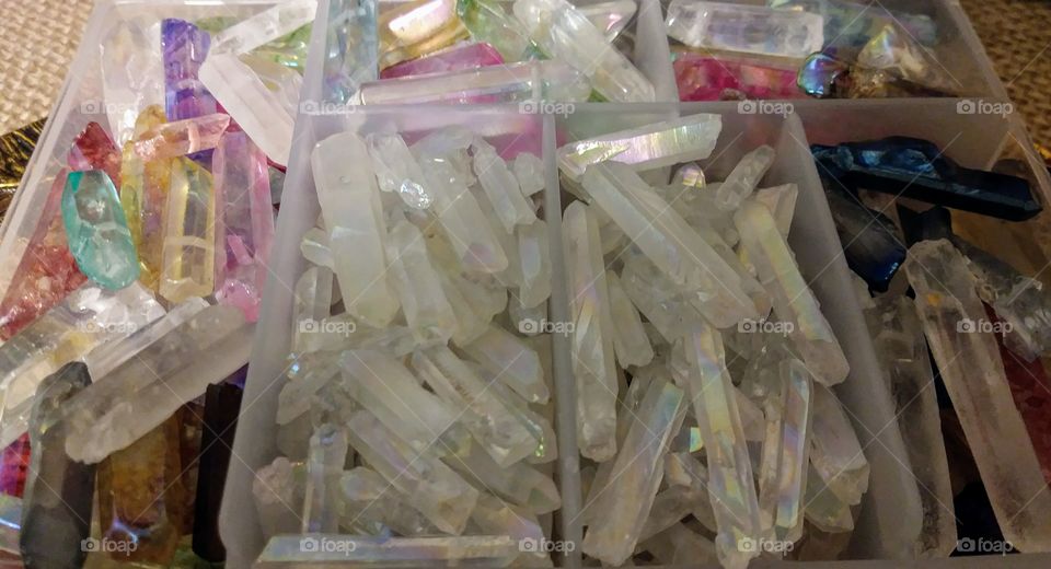This photo depicts a plastic organizer filled with genuine quartz crystal tips. The crystals are mostly white with some assorted colors thrown in.