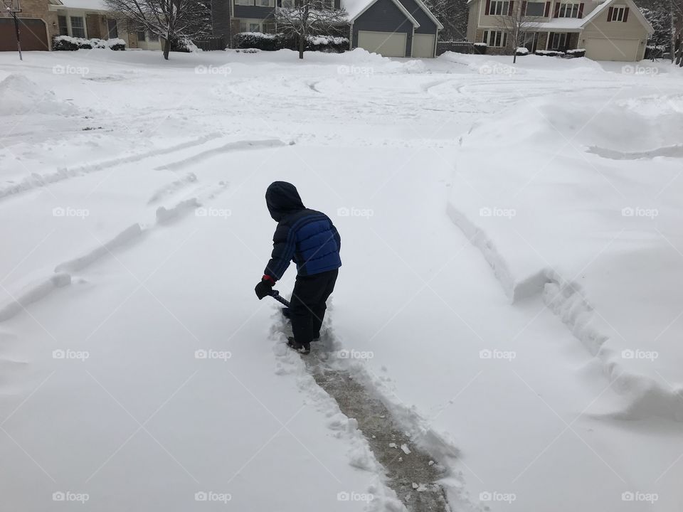 Boy shoveling 