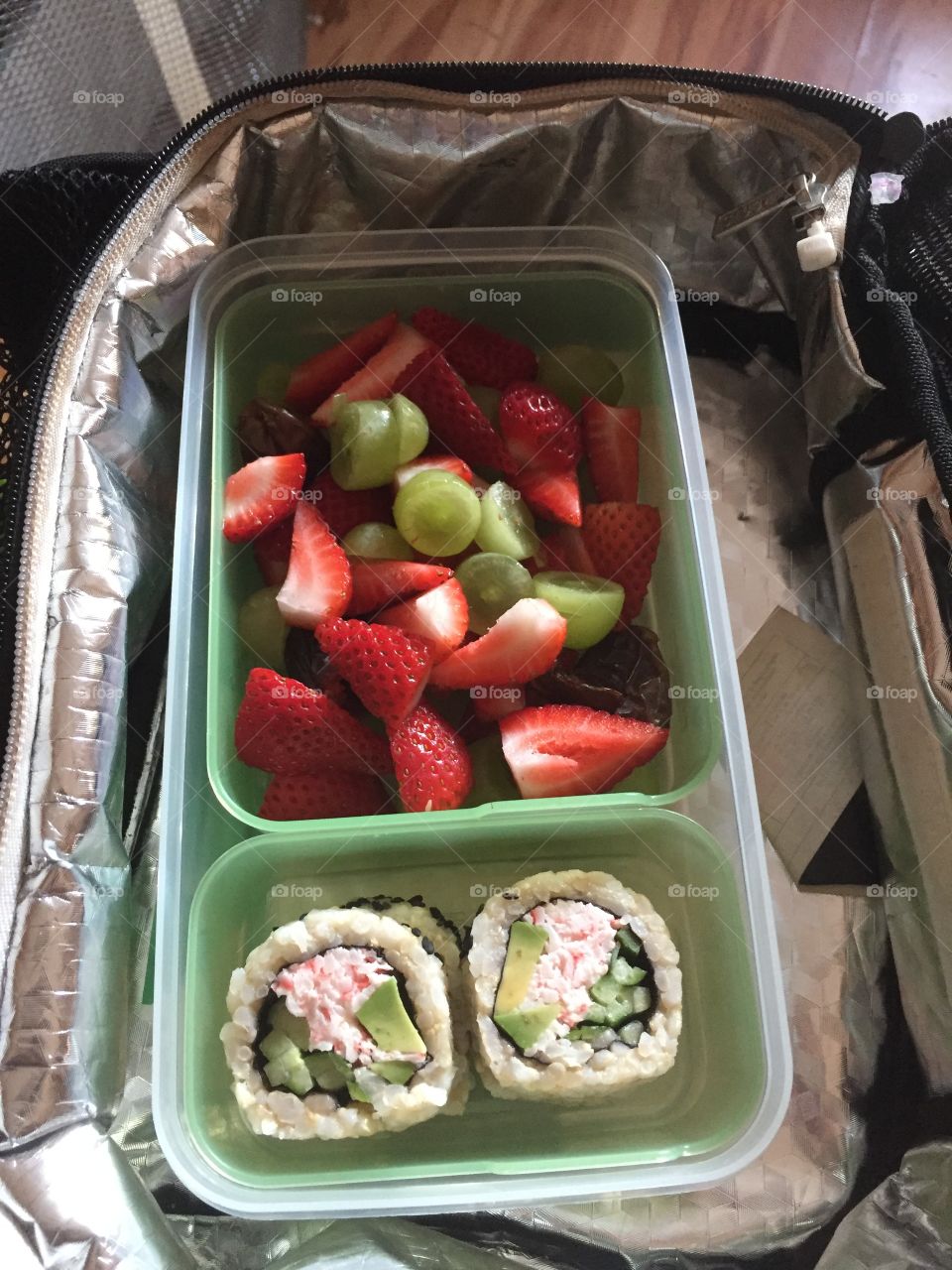 Unbelievably my child packed this healthy lunch of  California roll sushi and strawberry and grape salad!