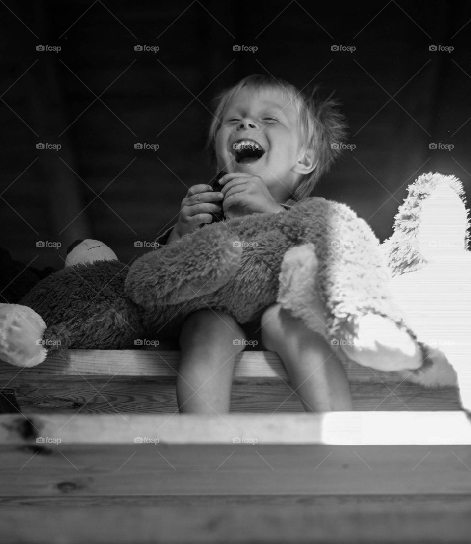 Boy sitting on the stairs and laughing.