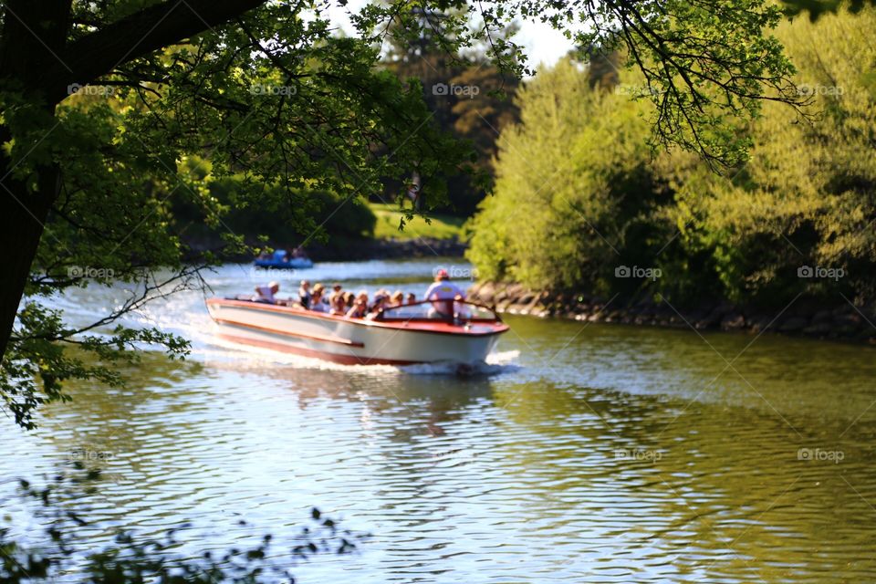 Photo of people traveling in a canalboat in summer in Malmö in Sweden 