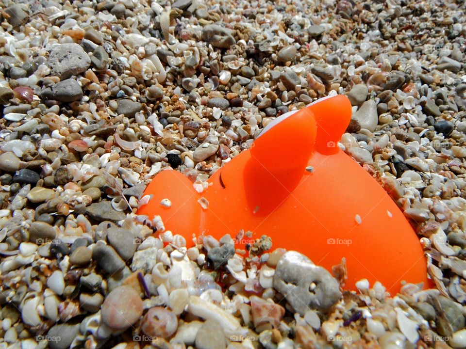 orange color story: toys in the seashore