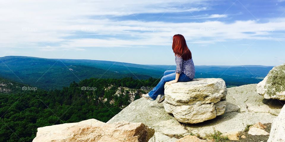 Hiker sitting on rock at hudson valley