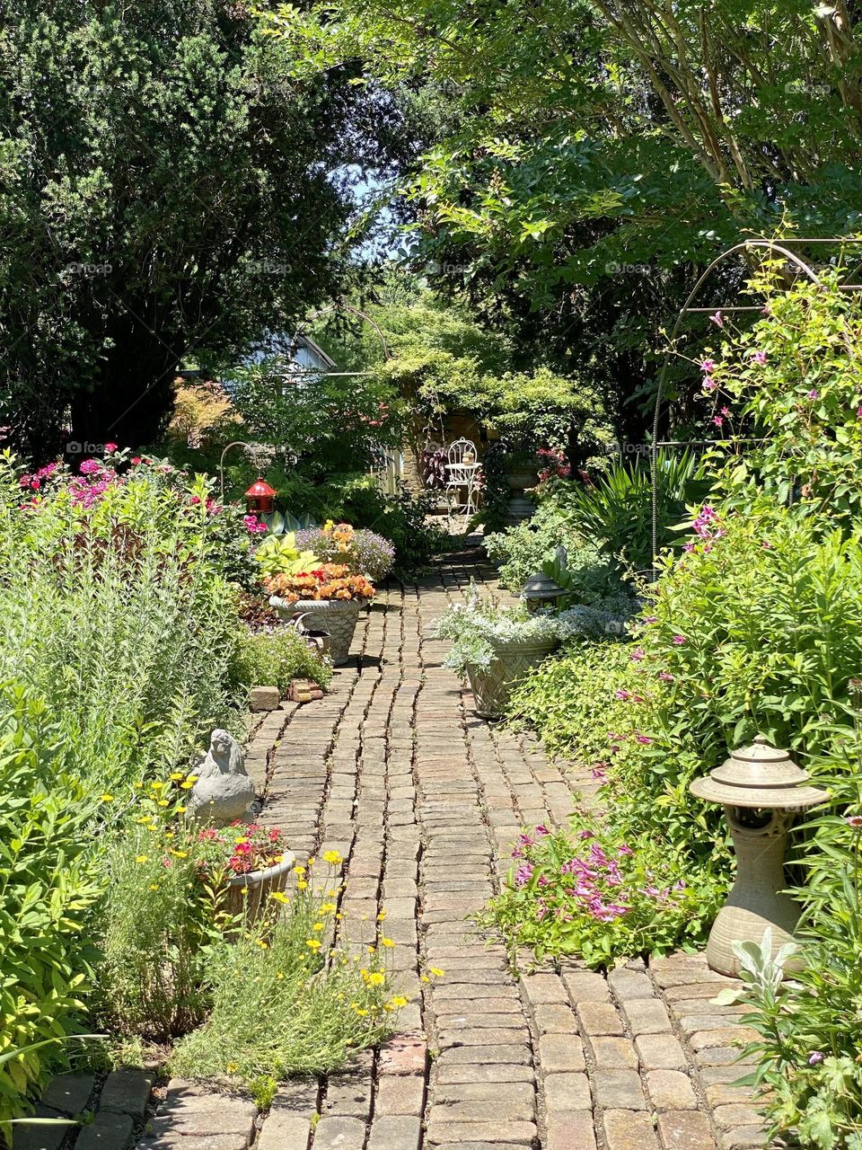 A brick path thru a garden