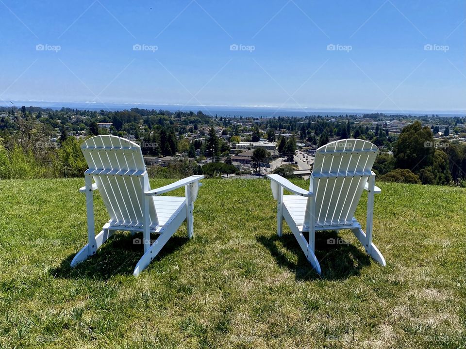 Adirondack chairs in a mountain looking over Santa Cruz California 