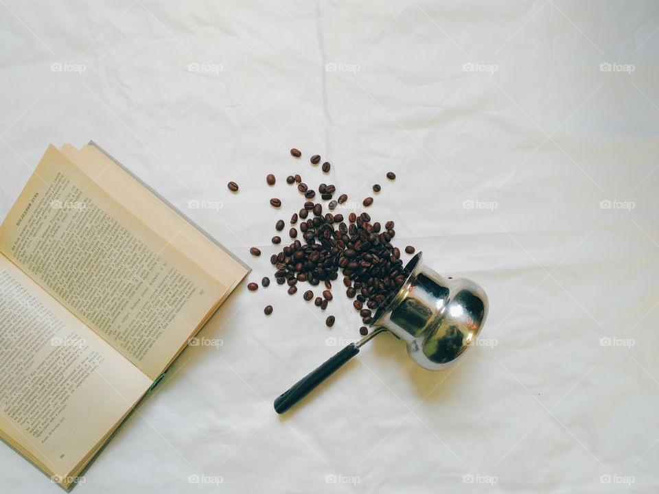 Turk, coffee beans and book on white background