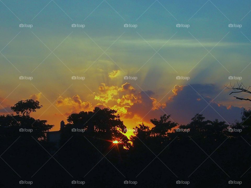 Ray of light in the cloudy sky at the sunset