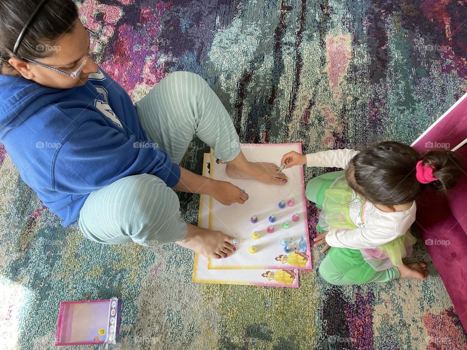 Toddler girl paints mommy’s toe nails, putting nail polish on mommy, toddler uses nail polish for the first time, making mommy pretty, beauty time with toddlers 