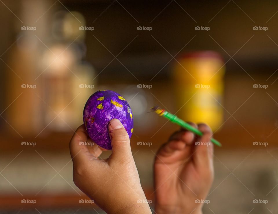 painting easter egg with brush