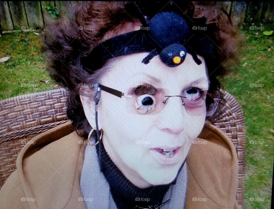 Woman with creepy Halloween eyes👀👁🕷Spider on headband with pic taken outside. She's a brunette with brown creepy eyes!