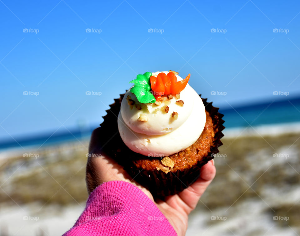 Close-up of hand holding cupcake