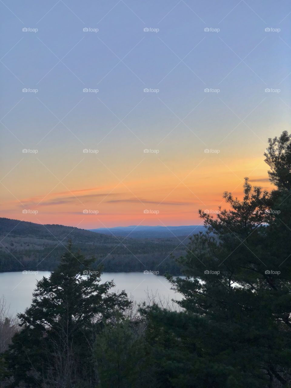 Colorful sunset over mountains and Eagle Lake in Acadia National Park in Bar Harbor, Maine USA, during Spring season.