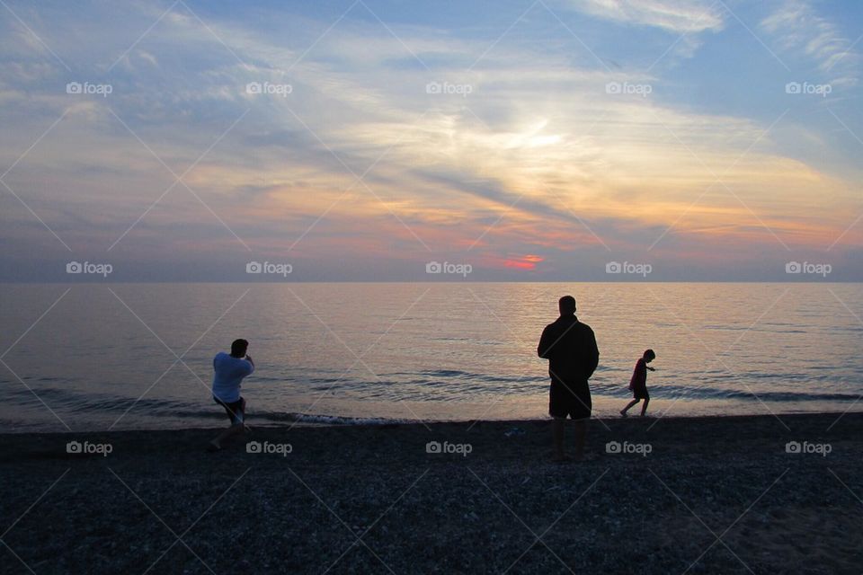 Boys skipping stones 