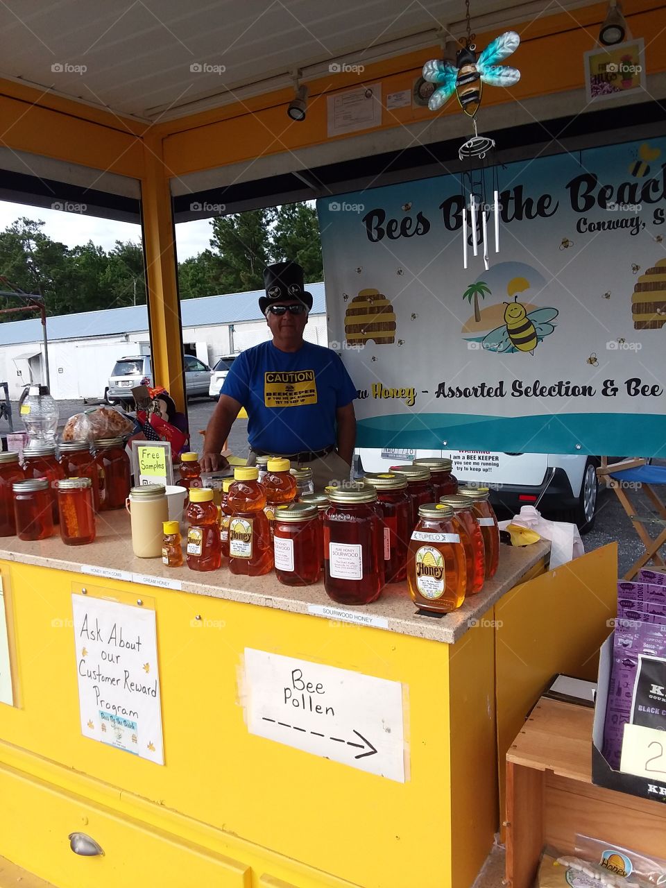 beekeeper selling his honey at the flea market it's summertime