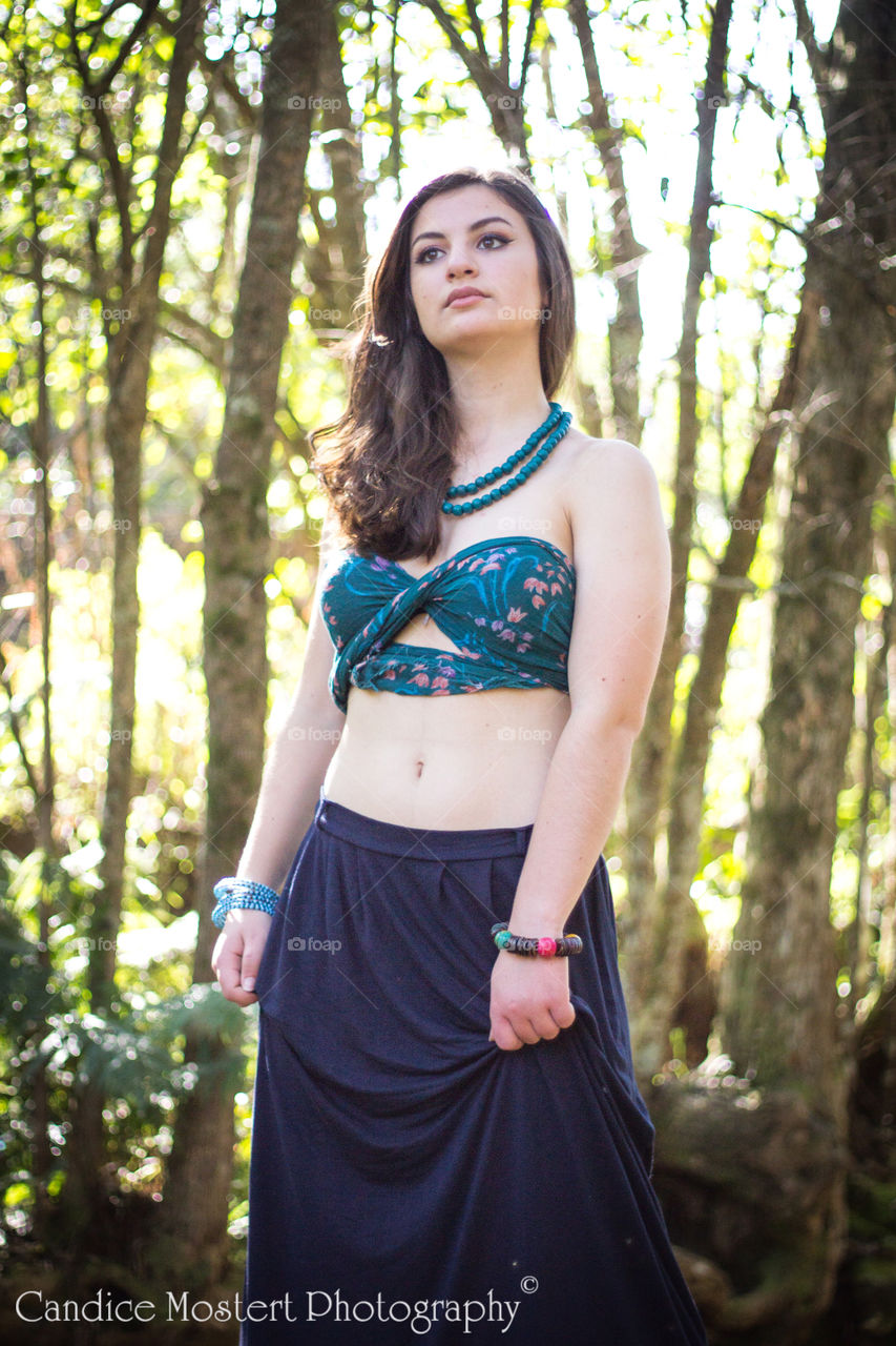 Portrait of a beautiful woman standing in forest