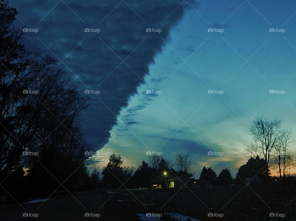 sunset illuminates divided sky half light half dark