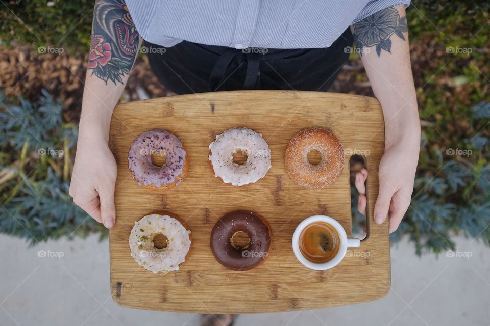 A tray of donuts with espresso. 