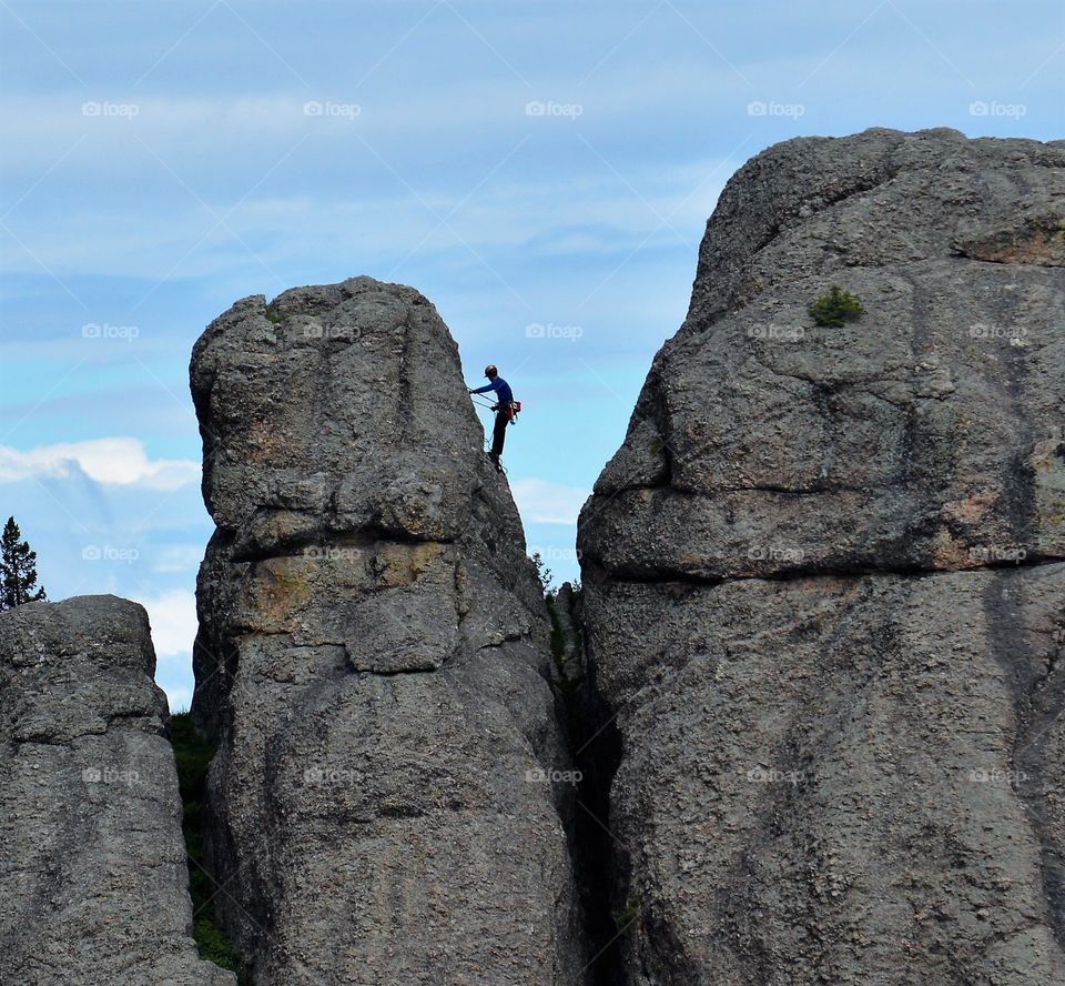 A person climbing rocky mountain