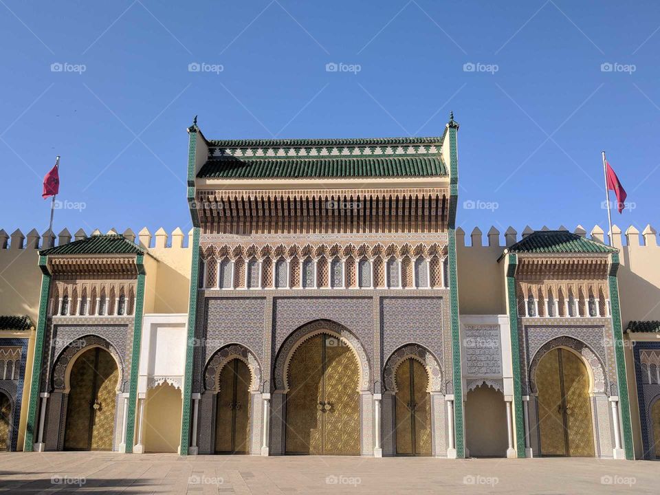 Royal Palace of Fez (Fes) in Morocco - Ornate, Beautiful Blue/White/Green/Yellow Chateau with Arches, Delicate Details, and Flags