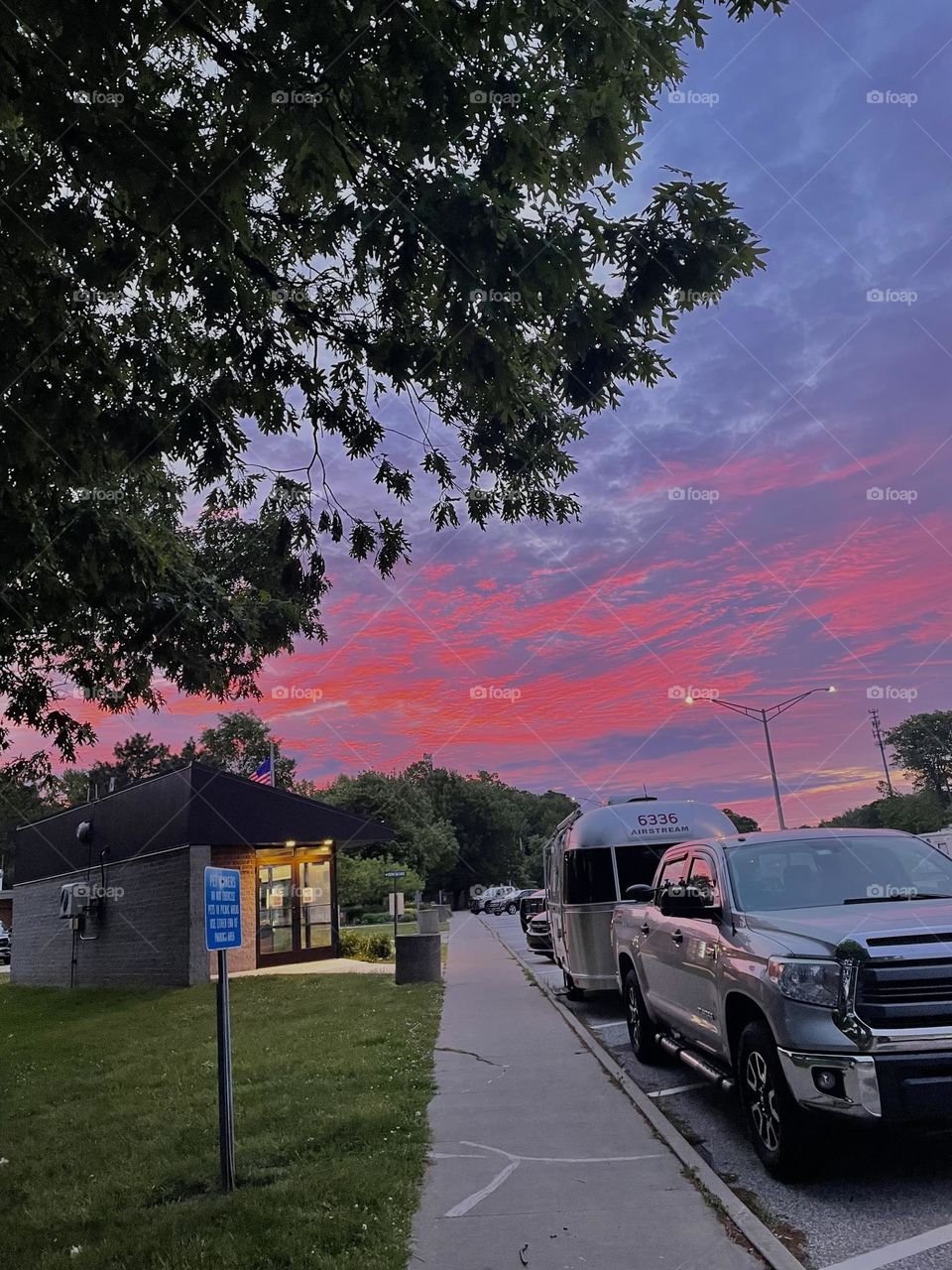relaxing with red skies at rest stop on a road trip 