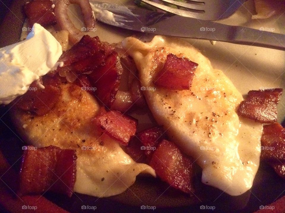 Mmmm who doesn't just love home made perogies, smothered in bacon, onions and sour cream! 👈   