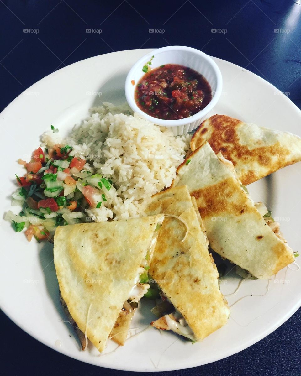 Quesadilla on plate with salsa and rice