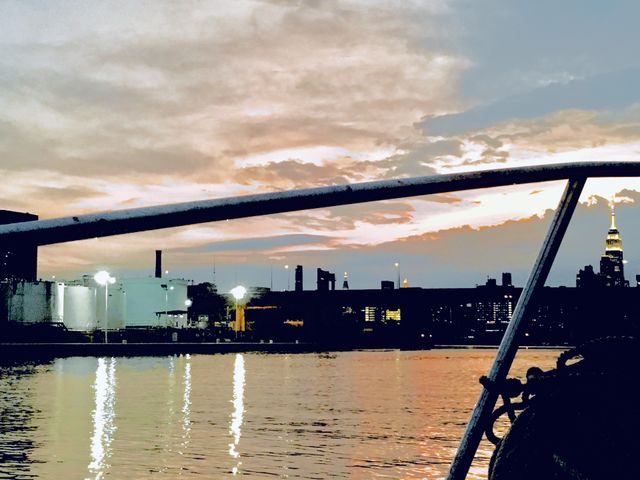 The East River at Newtown Creek in Long Island City, Queens, NY seen from our sailboat, the “Salvation” one evening in 2018. The setting sun is casting reflections in the water. Hypnotic Productions