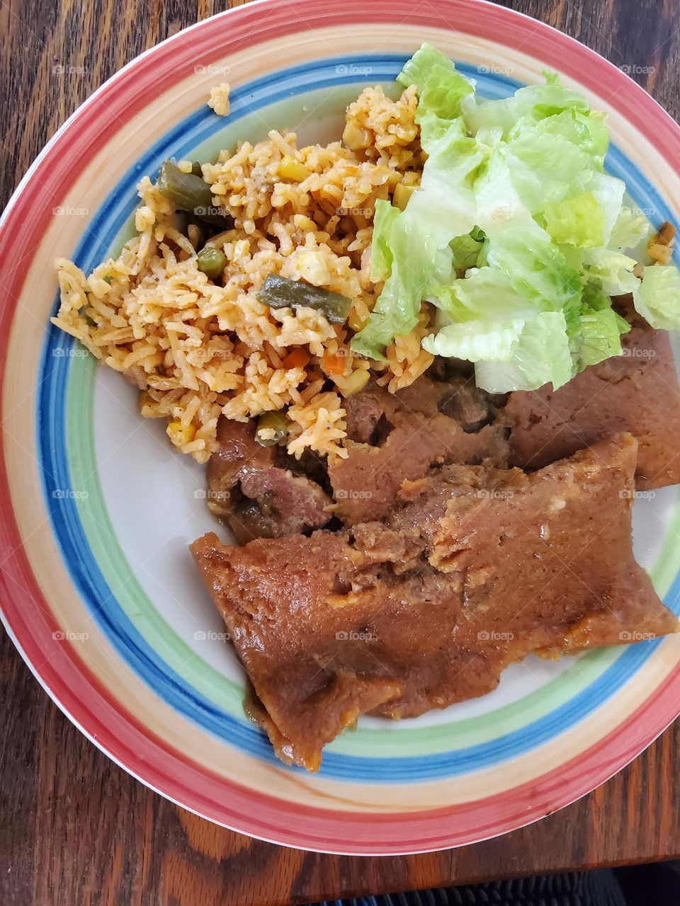 rice with vegetables, pasteles and salad.