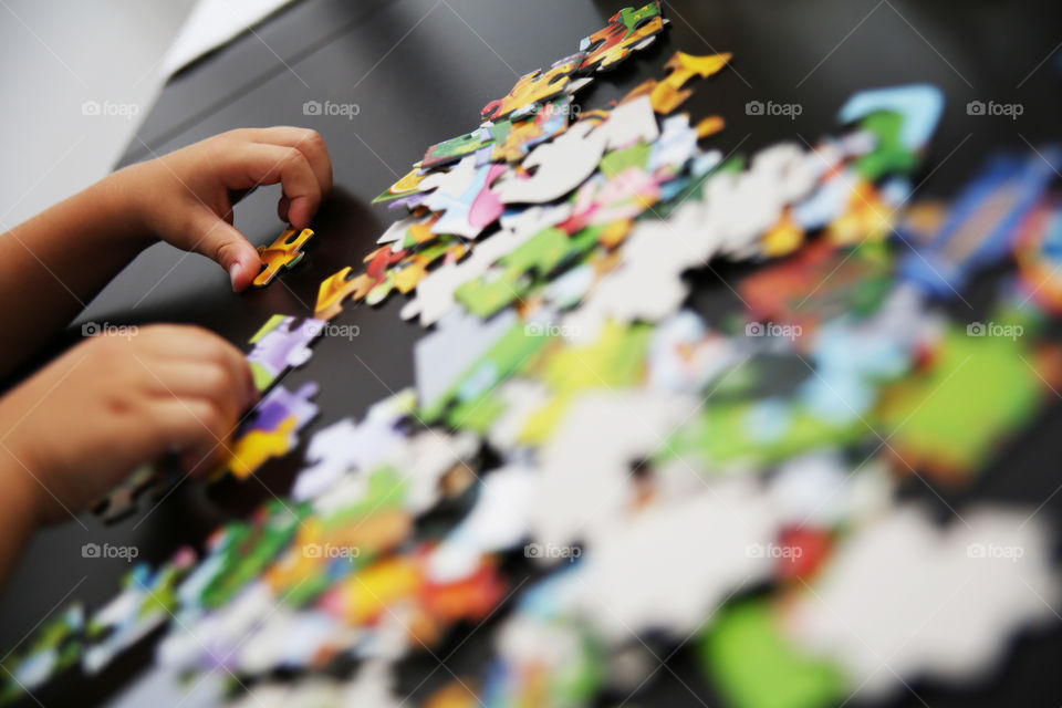 Kid playing with puzzles