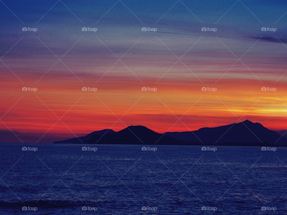 Cape of Miseno and Island of Ischia at Sunset  (Naples - Italy ).