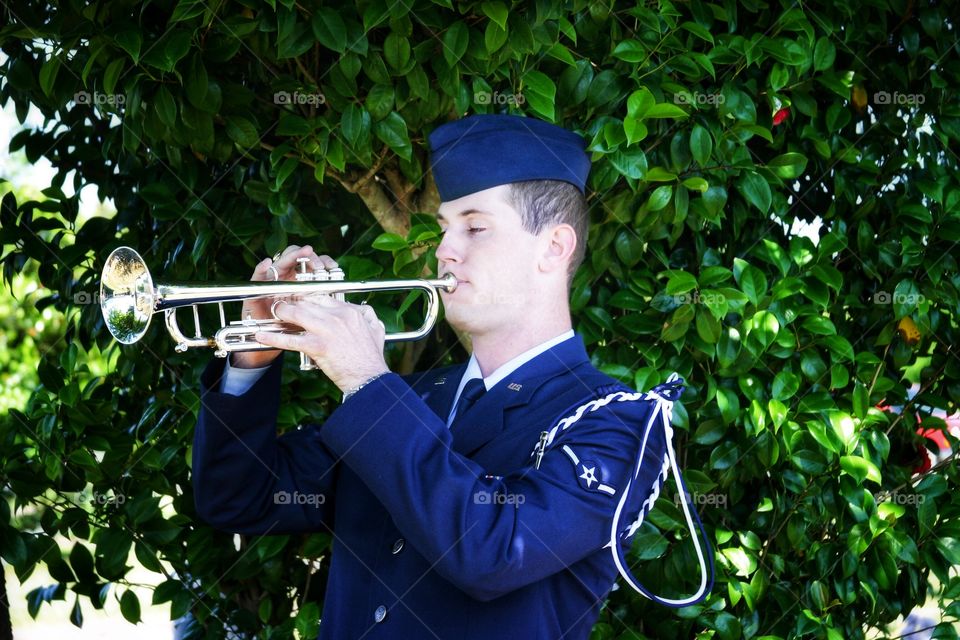 Air Force Bugler plays taps at a veteran’s funeral 