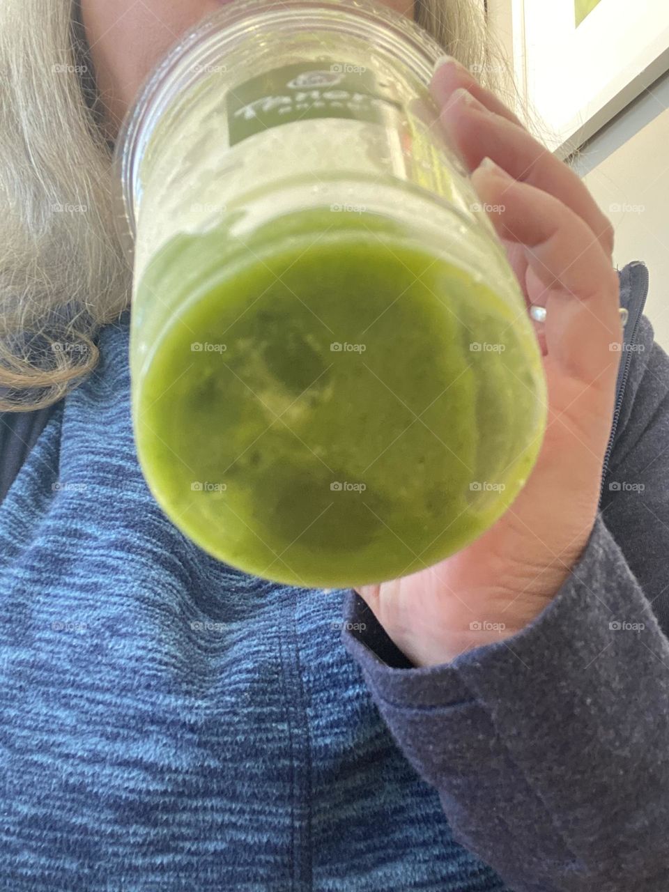 Me enjoying a green smoothie at a local Panera bread. It is made from peach and mango purees, white grape and Passionfruit juice concentrates, and spinach over ice. It is a delicious and nutritious start to the day. Green goodness!