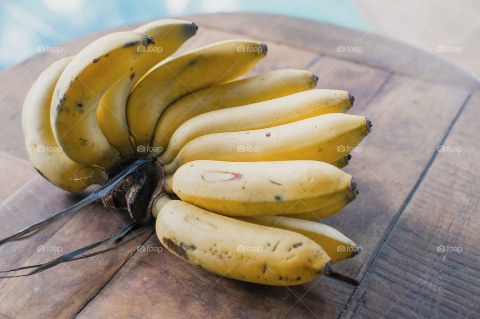 Yellow banana on a wooden table