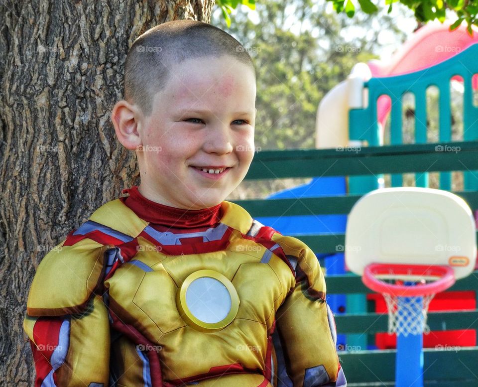 Smiling boy in superhero costume