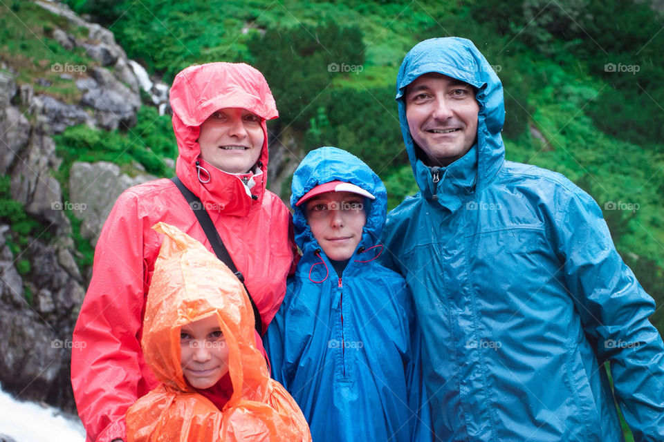 Family on mountain trail on a rainy day