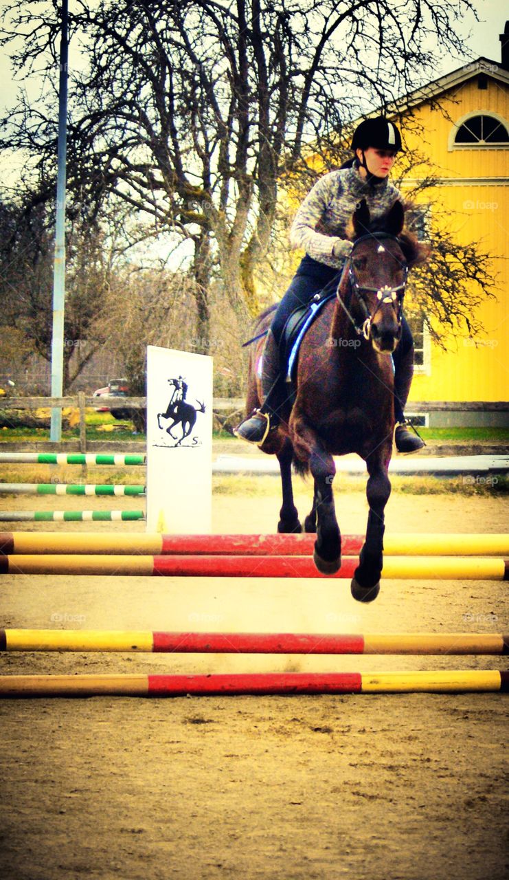 Girl jumping with her horse