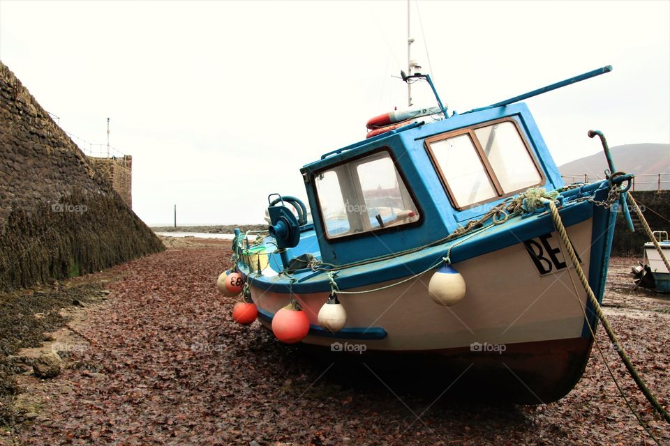 Small fishing boat in Lynmouth harbour  at low tide