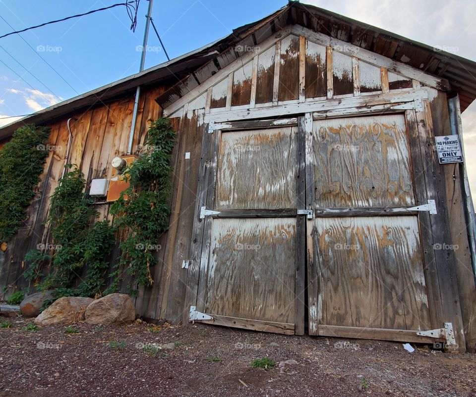 A weathered building still serves a purpose despite looking frail and fragile