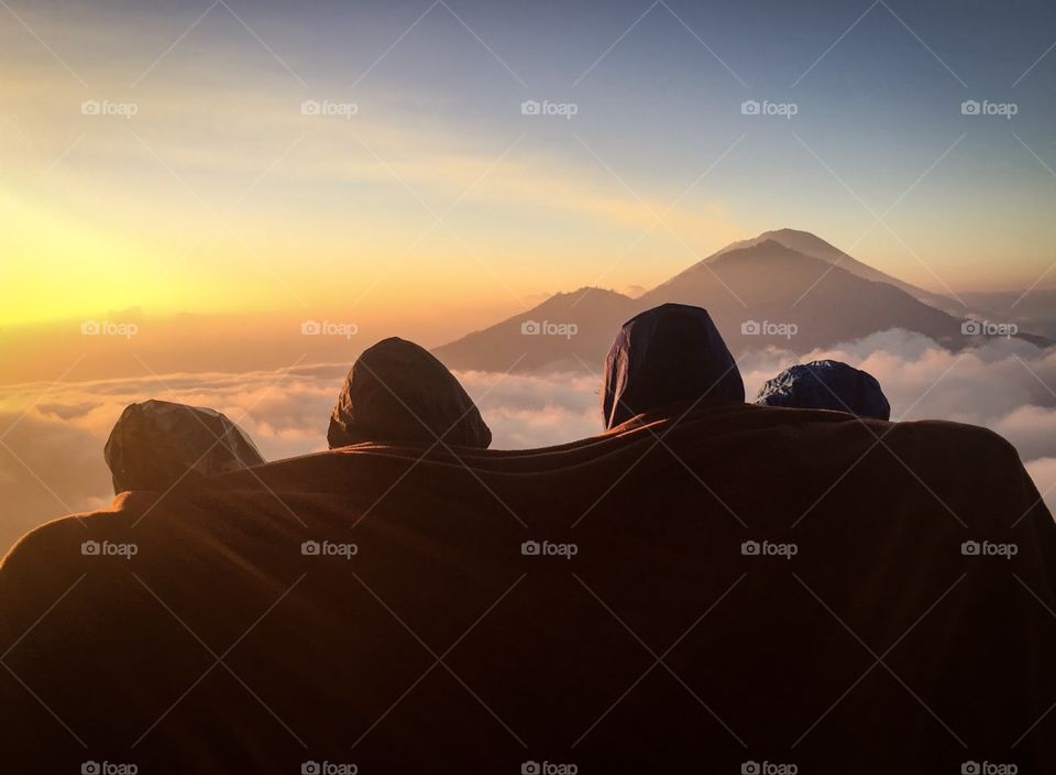 Friendship when waiting to sea beautiful sunrise in cold weather at Berbabu mountain, Indonesia 