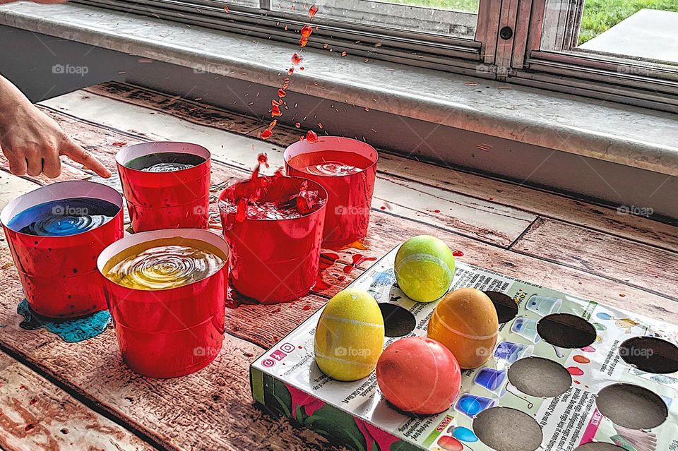 Brightly colored Easter eggs, springtime colored Easter eggs, egg splashes while being dyed, egg dying action shot, splashes of colorful water while dying Easter eggs 