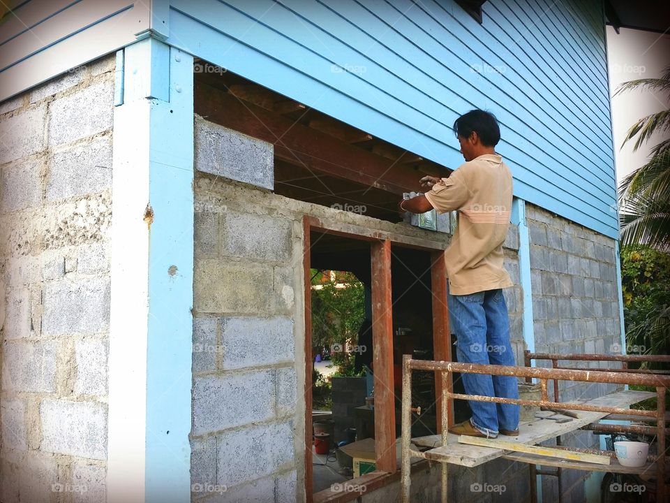 Worker.. Construction workers working on a house.