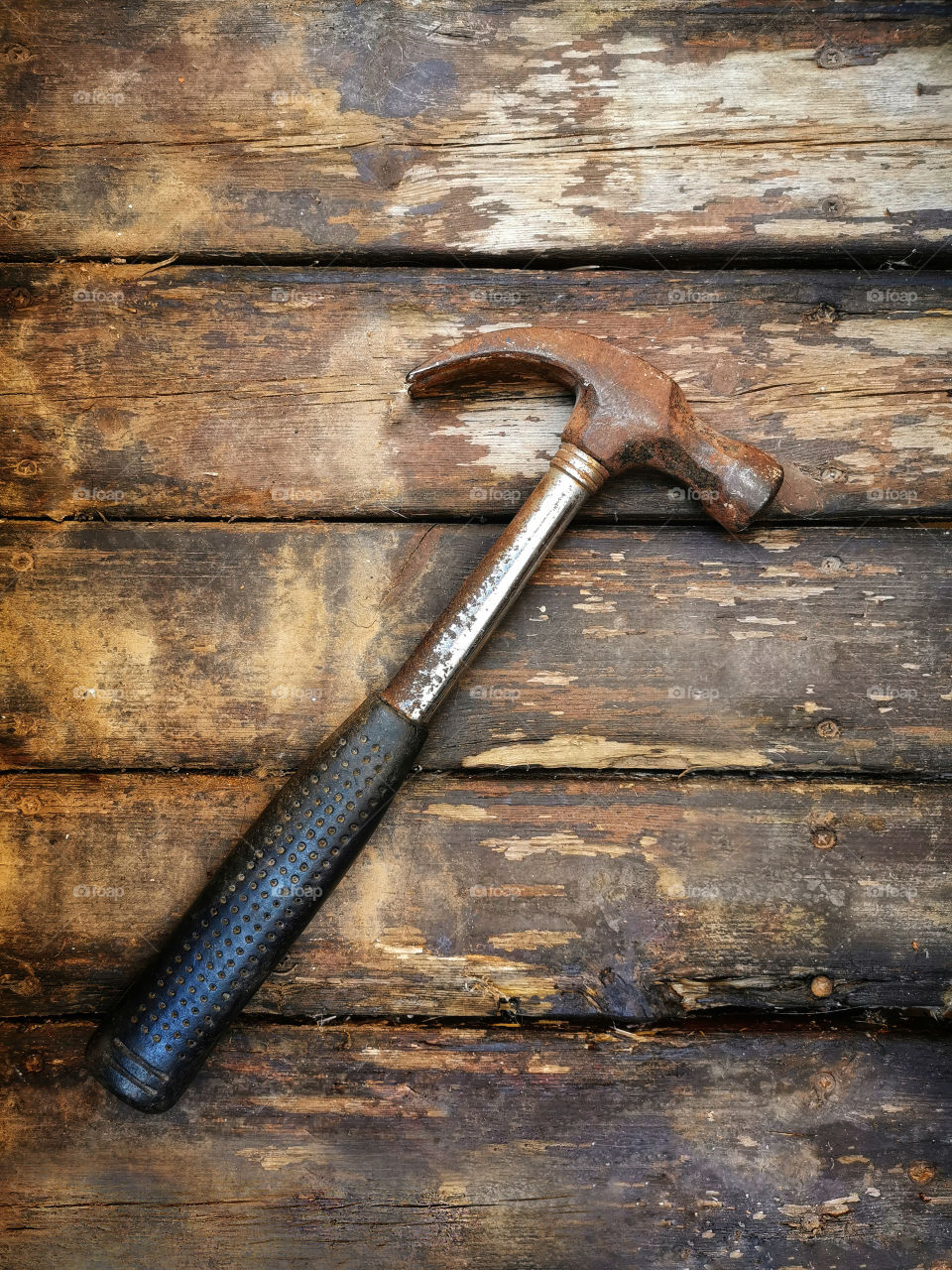 Old hammer on old wood.