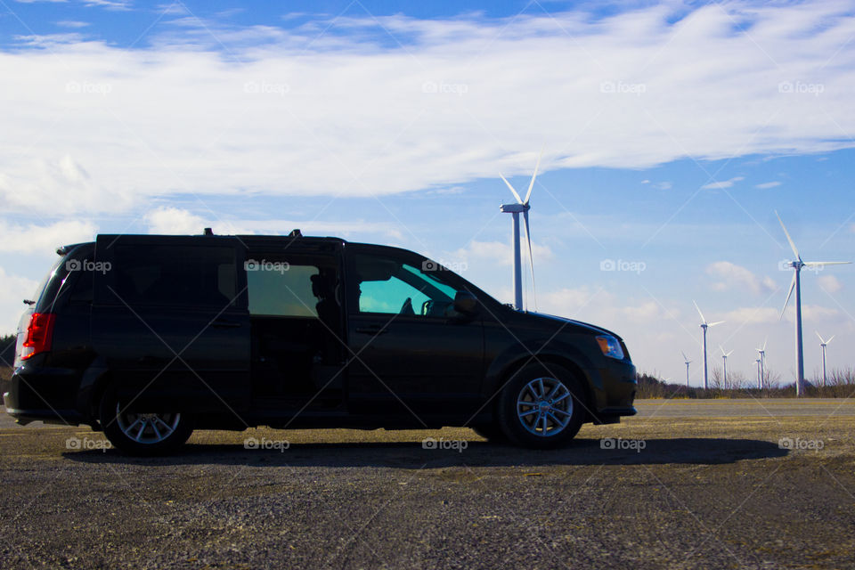 Family size vehicle, wind turbine, sky